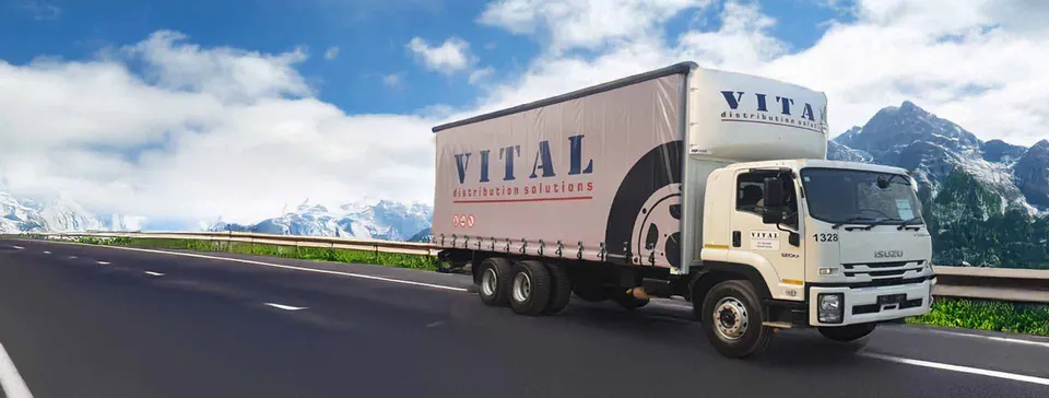 Vital rigid curtain-side truck on a mountain highway