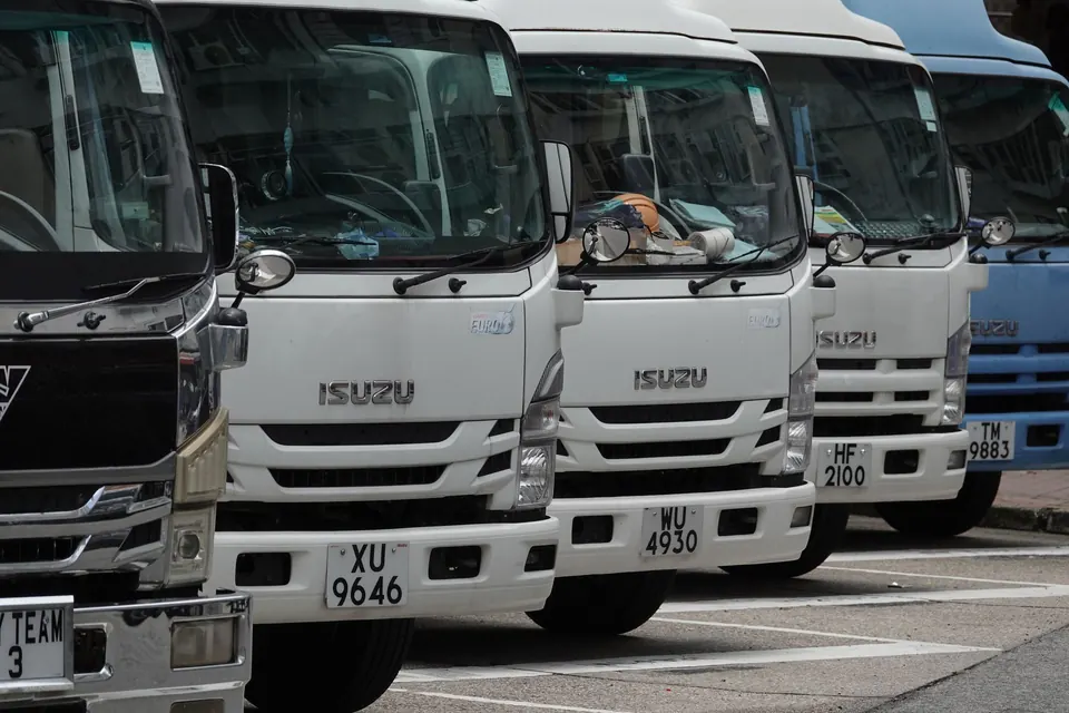 Row of Isuzu trucks ready for hire