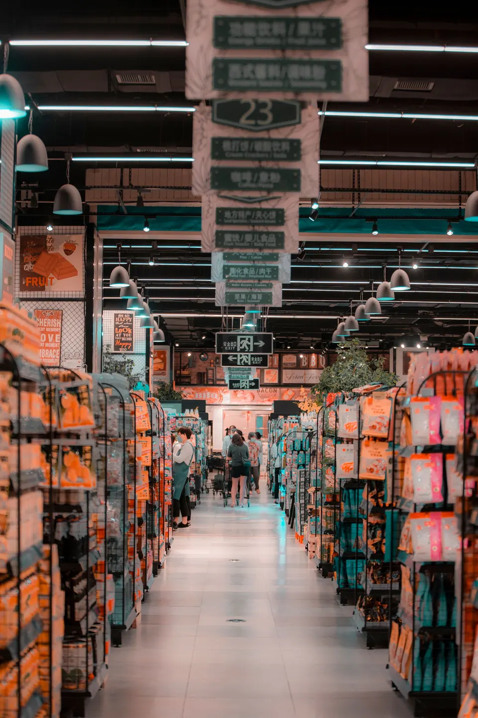 Shoppers in a well-stocked supermarket aisle